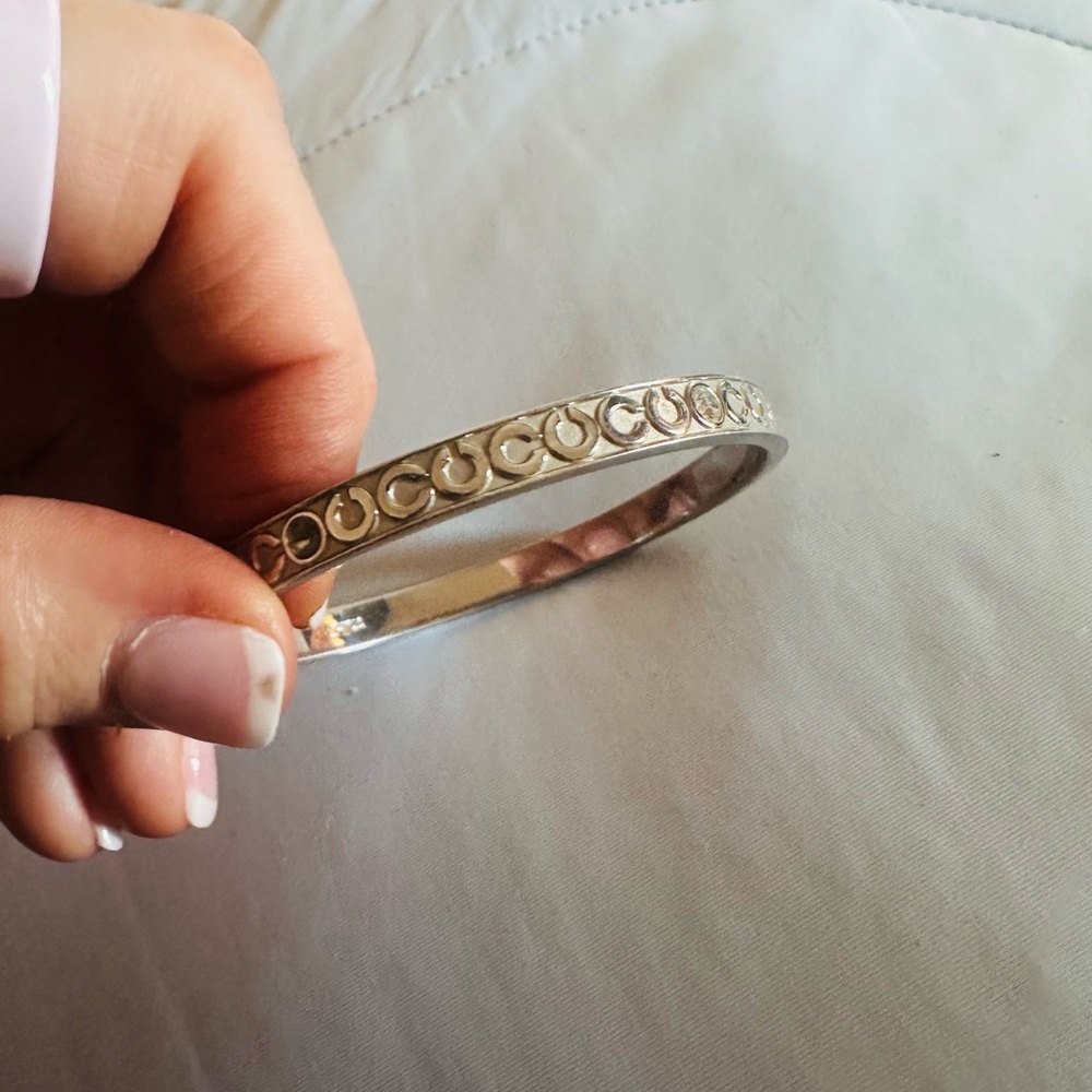 Coach Silver -toned bangle bracelet featuring a "Signature C" pattern